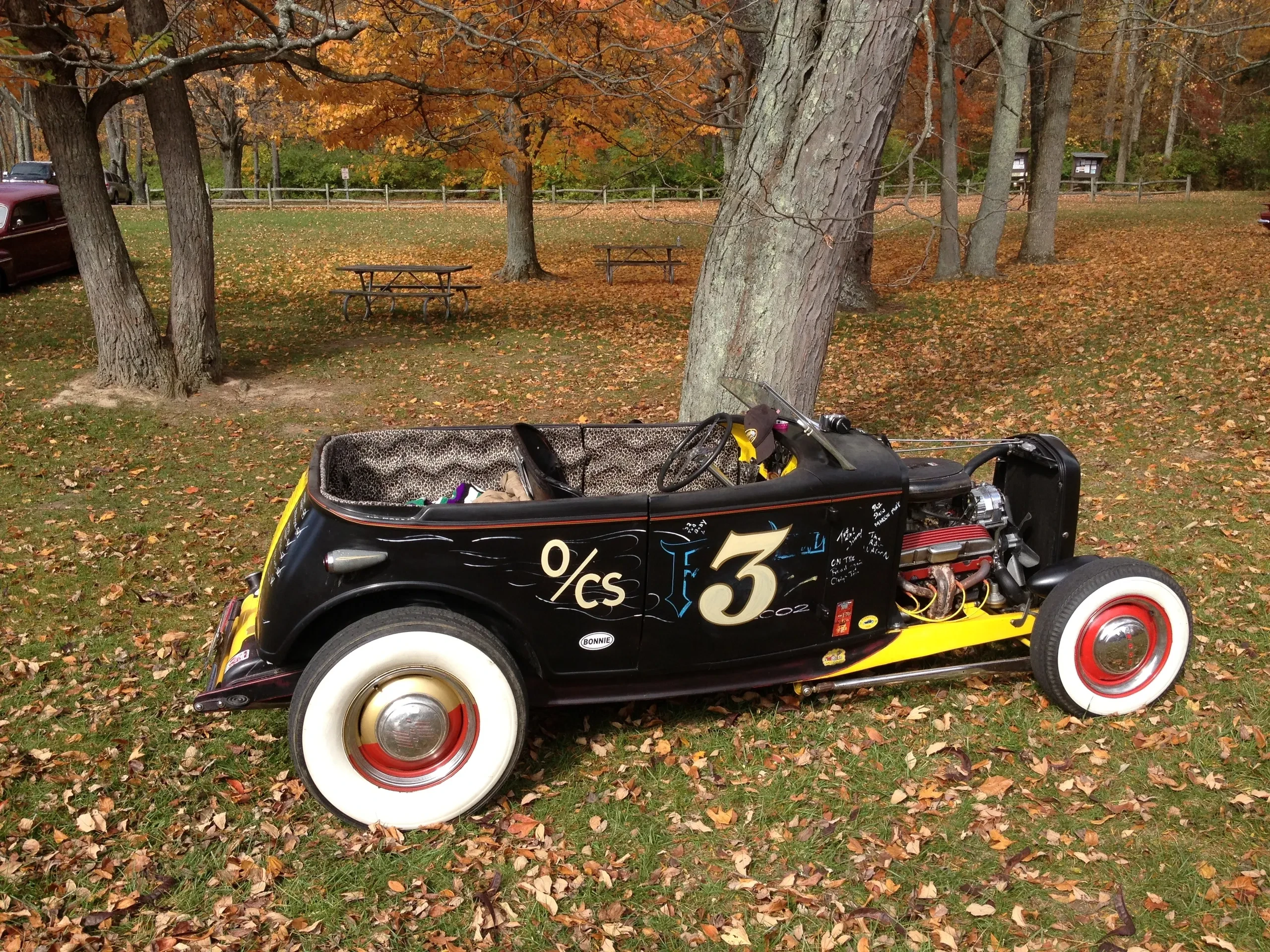 Black hot rod roadster with number 3 in autumn park