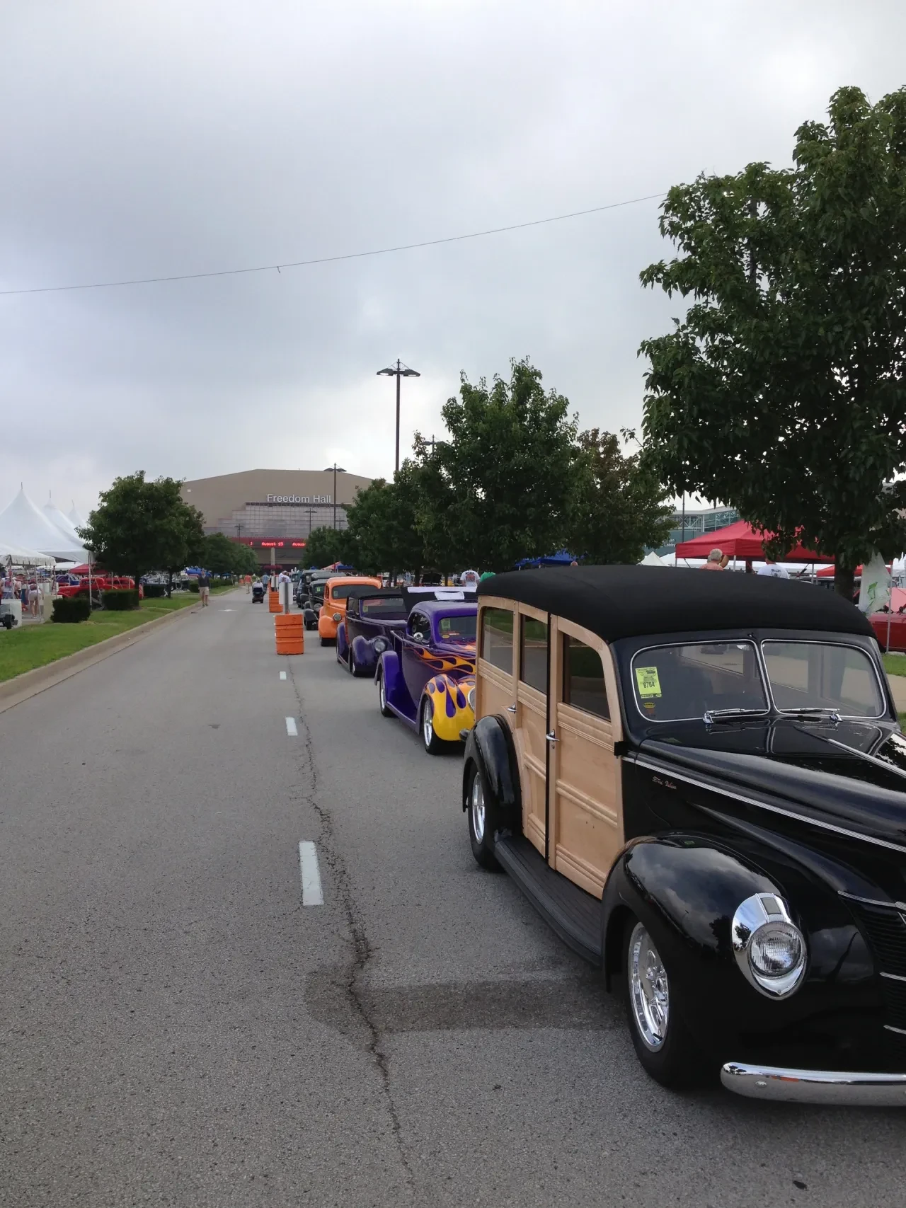 Classic cars lined up at outdoor event