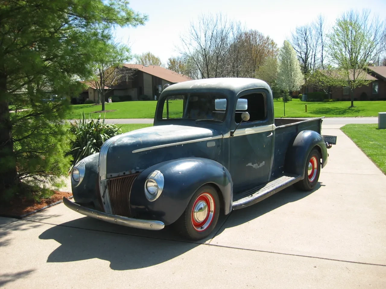 Blue vintage pickup truck driveway