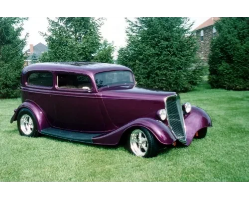 Purple vintage sedan on lawn